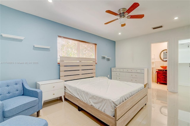 bedroom with light tile patterned floors, ensuite bathroom, visible vents, and recessed lighting