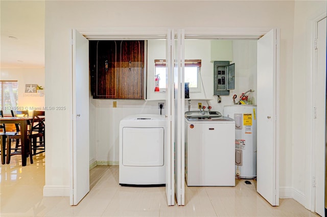 clothes washing area featuring electric panel, baseboards, separate washer and dryer, and electric water heater