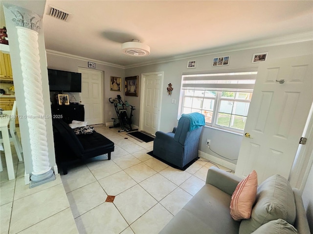 living area with ornamental molding, light tile patterned flooring, visible vents, and ornate columns