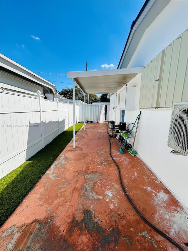 view of patio with ac unit and a fenced backyard