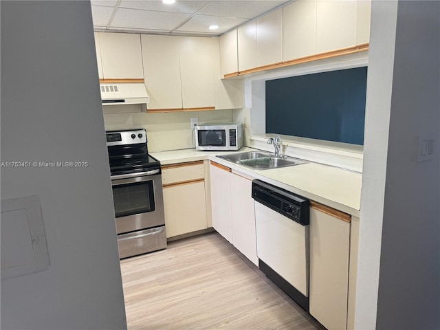 kitchen featuring light countertops, a sink, ventilation hood, stainless steel range with electric stovetop, and dishwasher