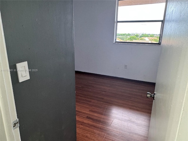 spare room featuring wood finished floors