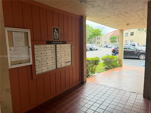 view of community with mail area and uncovered parking