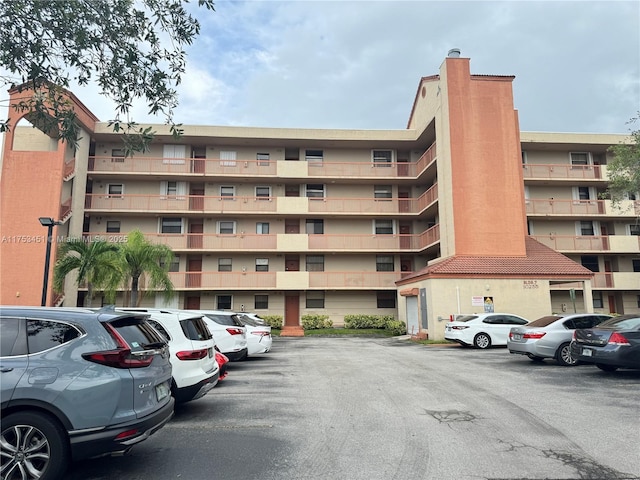 view of property featuring uncovered parking