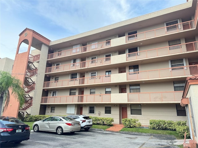 view of building exterior with uncovered parking