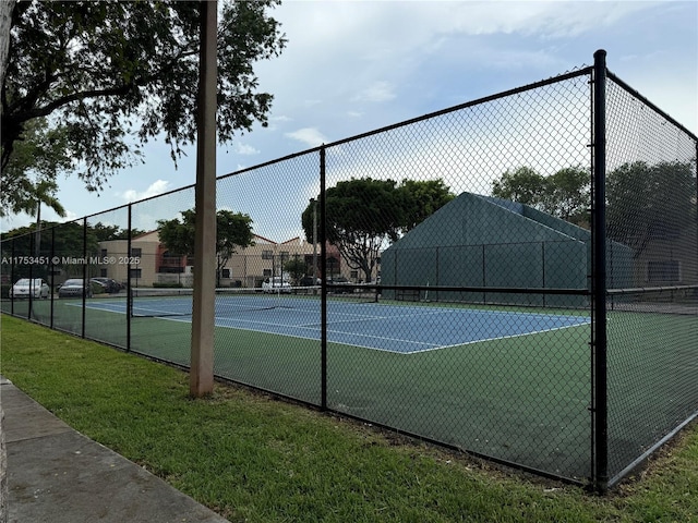 view of tennis court with fence