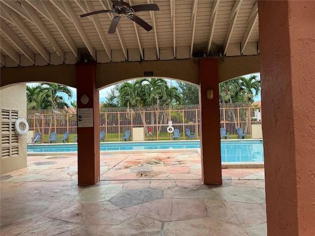 community pool featuring ceiling fan, a patio, and a fenced backyard