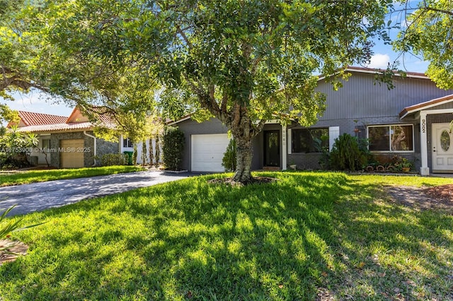 view of front of house with driveway, an attached garage, a front lawn, and brick siding