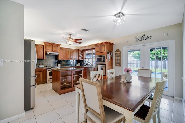 dining area with light tile patterned floors, french doors, visible vents, and a ceiling fan