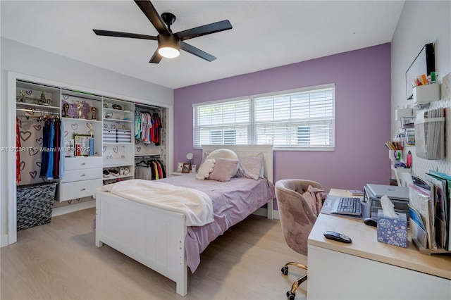 bedroom with light wood-type flooring, a closet, and ceiling fan