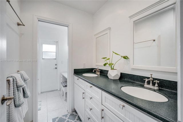 full bath featuring tile patterned flooring, a sink, and double vanity