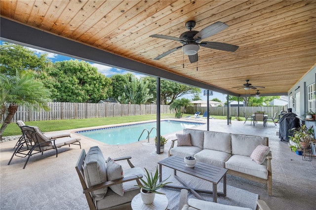 view of pool featuring a patio, outdoor lounge area, a fenced backyard, and a fenced in pool