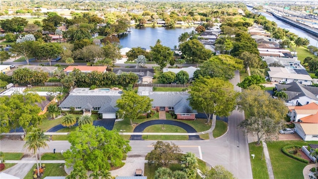 drone / aerial view with a residential view and a water view