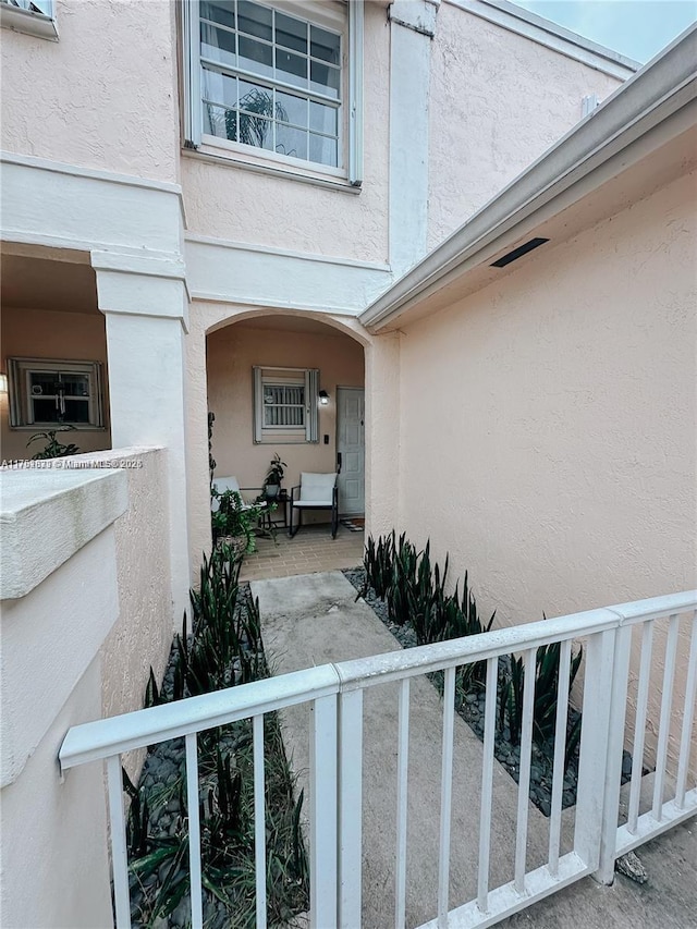 doorway to property featuring a patio area and stucco siding