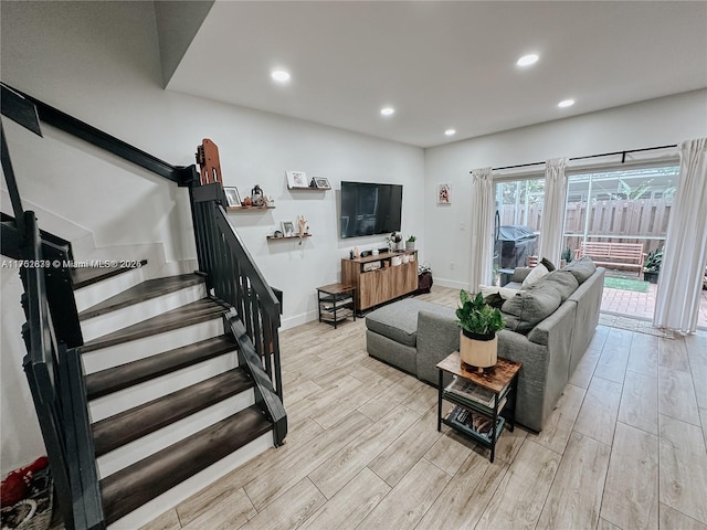 living area with baseboards, stairway, wood finished floors, and recessed lighting