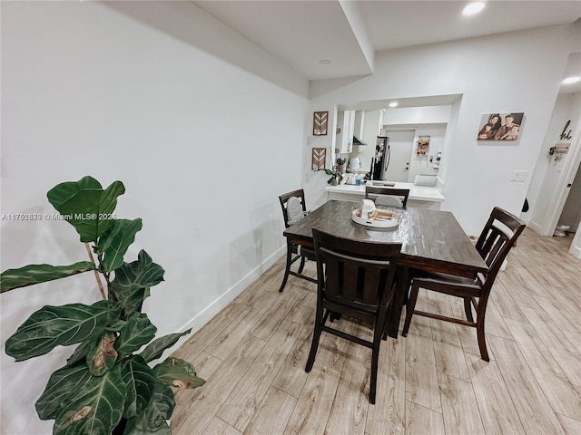 dining area featuring light wood-type flooring, baseboards, and recessed lighting