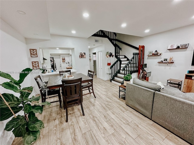 dining area with stairs, light wood finished floors, visible vents, and recessed lighting