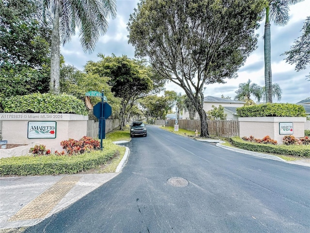 view of road featuring traffic signs and curbs