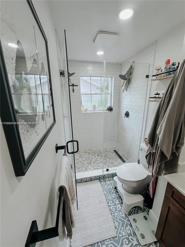 full bathroom with toilet, a shower stall, and vanity