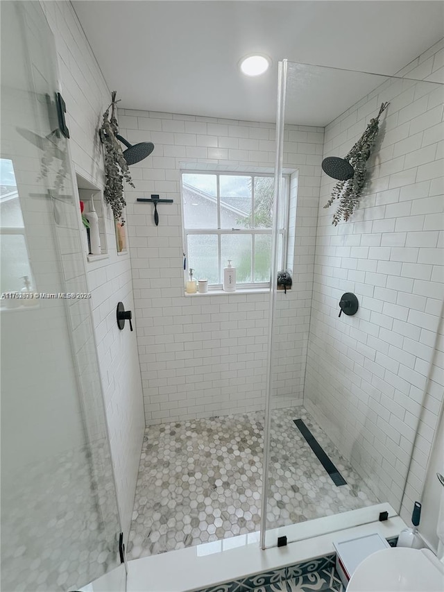 bathroom featuring a shower stall and toilet