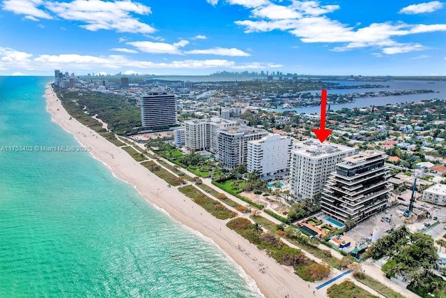 birds eye view of property featuring a view of the beach, a city view, and a water view