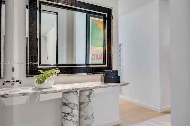 bathroom featuring baseboards and wood finished floors