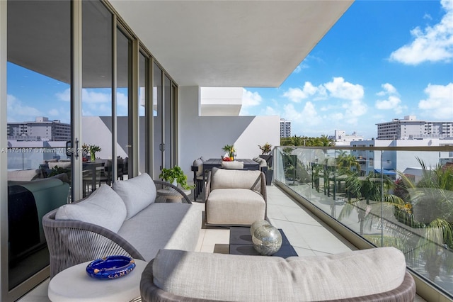 balcony with a view of city and an outdoor hangout area