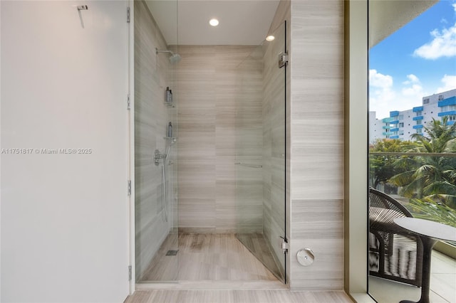 bathroom with a view of city and a stall shower