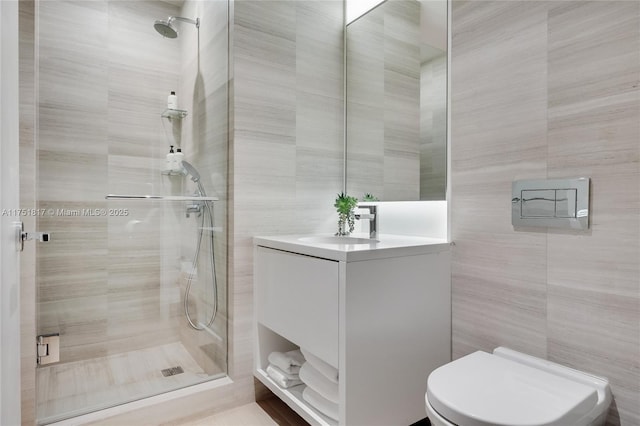 bathroom with a stall shower and tile walls