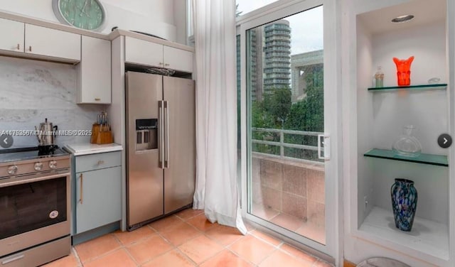 kitchen featuring appliances with stainless steel finishes, light countertops, white cabinetry, and light tile patterned floors