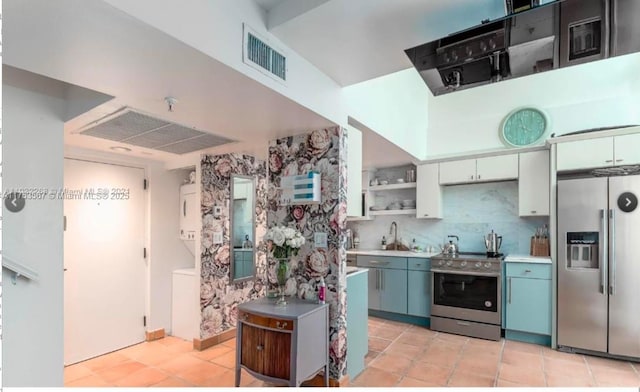 kitchen featuring stainless steel appliances, white cabinetry, visible vents, decorative backsplash, and open shelves