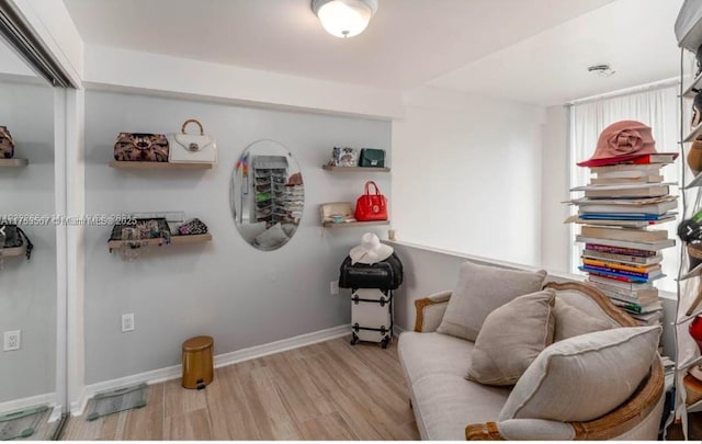 living area with wood finished floors and baseboards