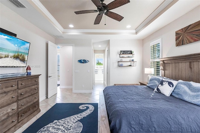 bedroom with visible vents, multiple windows, and a tray ceiling