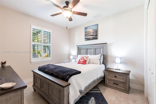 bedroom with visible vents, baseboards, and a ceiling fan