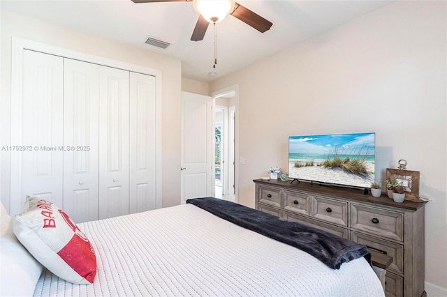 bedroom featuring ceiling fan, a closet, and visible vents