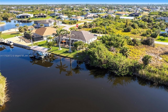 drone / aerial view with a residential view and a water view