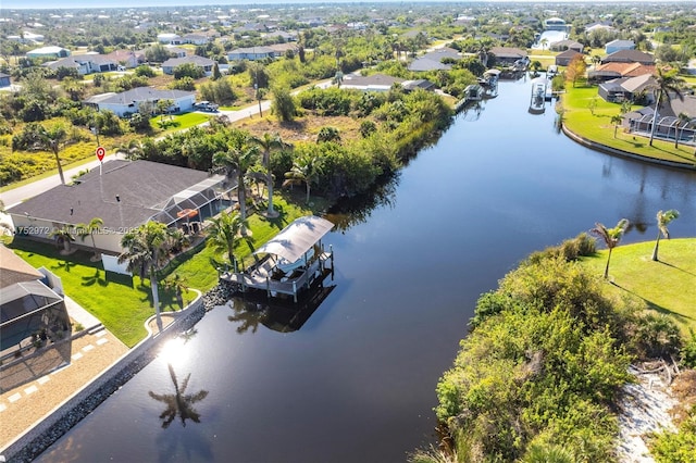 birds eye view of property with a residential view and a water view