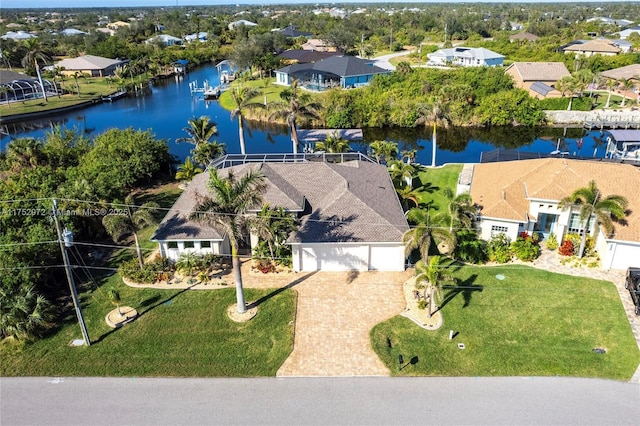 birds eye view of property with a water view and a residential view