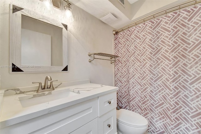 bathroom with a shower with shower curtain, visible vents, vanity, and toilet