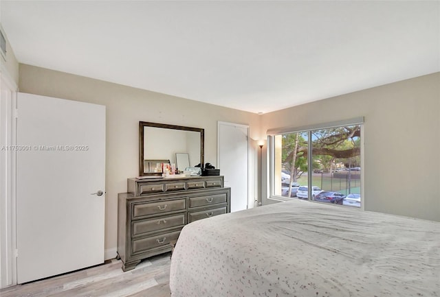 bedroom with access to outside and light wood finished floors