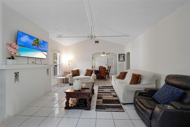 living room featuring arched walkways, light tile patterned floors, lofted ceiling, visible vents, and ceiling fan