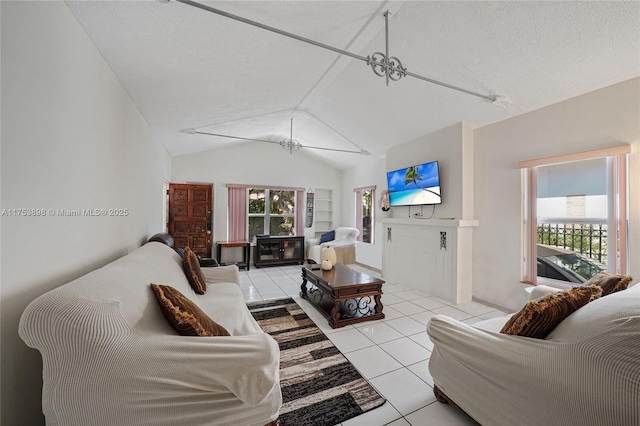 living room featuring lofted ceiling, light tile patterned floors, and a textured ceiling