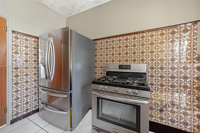 kitchen with tasteful backsplash, tile patterned flooring, stainless steel appliances, and a textured ceiling