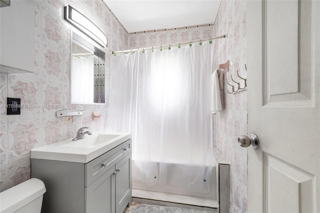 bathroom with vanity, toilet, and shower / bathtub combination with curtain