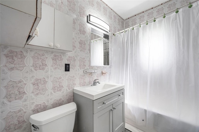 full bathroom with shower / bath combo, vanity, and toilet