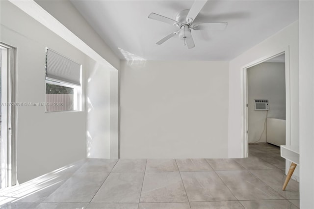 unfurnished room with a wall unit AC, tile patterned flooring, and ceiling fan