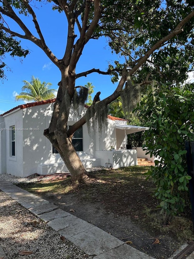 view of side of home with stucco siding