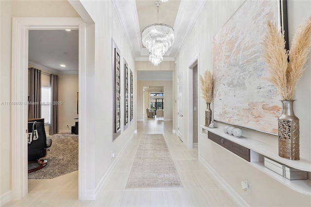 corridor with ornamental molding, a wealth of natural light, a notable chandelier, and light tile patterned floors