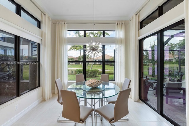sunroom with a healthy amount of sunlight and an inviting chandelier