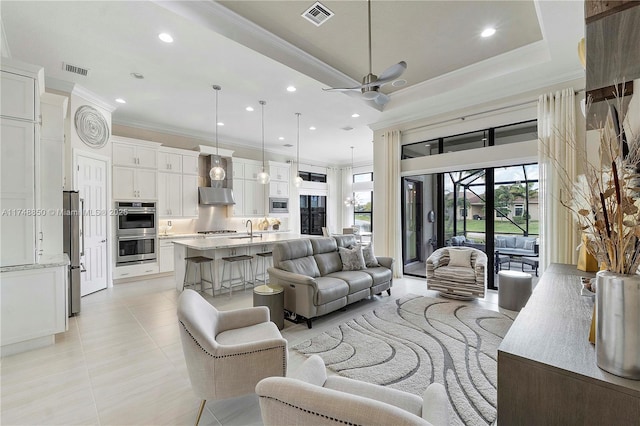 living room with light tile patterned flooring, recessed lighting, visible vents, and ornamental molding